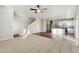 Open living room and kitchen with hardwood and carpeted floors at 2974 Oxley St, Strasburg, CO 80136