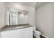 Clean bathroom with white vanity, toilet and large mirror at 2974 Oxley St, Strasburg, CO 80136