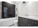 Bathroom with dark hexagonal tile and floating vanity at 7916 Forest Keep Cir, Parker, CO 80134