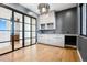 Modern home office with built-in cabinetry and hardwood floors at 7916 Forest Keep Cir, Parker, CO 80134