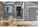 Stone accents and a welcoming porch add charm to the home entrance at 3153 Eagle Claw Pl, Castle Rock, CO 80108