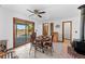 Bright dining area with wood table and chairs, wood-burning stove, and access to deck at 16621 Horizon Dr, Brighton, CO 80601