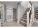 Basement stairs with carpet runner and metal railing at 2860 S Hudson St, Denver, CO 80222