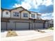 Townhouse exterior with two-car garage and landscaping at 1481 Harebell St, Berthoud, CO 80513