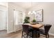 Modern dining area with wood table and leather chairs at 1481 Harebell St, Berthoud, CO 80513