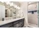 Modern bathroom with double vanity and walk-in shower at 1481 Harebell St, Berthoud, CO 80513