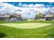 Community putting green with surrounding homes at 1481 Harebell St, Berthoud, CO 80513