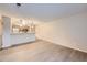 Living room with laminate flooring and open concept to kitchen at 8853 Colorado Blvd # A-106, Thornton, CO 80229