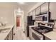 Galley kitchen with stainless steel appliances and light grey cabinets at 8853 Colorado Blvd # A-106, Thornton, CO 80229
