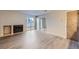 Living room with laminate wood flooring, fireplace, and access to a patio at 8853 Colorado Blvd # A-106, Thornton, CO 80229