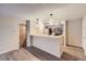 Living room with laminate flooring and kitchen with breakfast bar at 8853 Colorado Blvd # A-106, Thornton, CO 80229