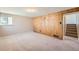 Finished basement room with carpeted floor and wood-paneled wall at 3055 Carson St, Aurora, CO 80011