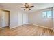 Light-filled bedroom featuring hardwood floors and a double door closet at 3055 Carson St, Aurora, CO 80011