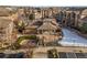 Community view with pond, clubhouse, and parking at 10805 Twenty Mile Rd # 307, Parker, CO 80134