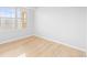 Well-lit bedroom featuring a large window and light wood flooring at 10805 Twenty Mile Rd # 307, Parker, CO 80134