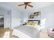 Light and airy bedroom with a queen bed, hardwood floors, and a ceiling fan at 10805 Twenty Mile Rd # 307, Parker, CO 80134