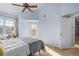 Bright bedroom with a queen bed, hardwood floors, and private balcony access at 10805 Twenty Mile Rd # 307, Parker, CO 80134