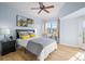 Cozy bedroom with a ceiling fan, large windows, and access to a balcony at 10805 Twenty Mile Rd # 307, Parker, CO 80134