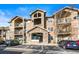 Tan three-story building with balconies and ample parking at 10805 Twenty Mile Rd # 307, Parker, CO 80134