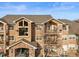 Three-story building with balconies, stone accents, and parking at 10805 Twenty Mile Rd # 307, Parker, CO 80134