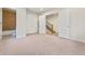 Bright bedroom with carpeting, and access to a full bathroom and staircase at 163 S Harrison St, Denver, CO 80209