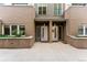 Modern building with two entrances and manicured landscaping at 163 S Harrison St, Denver, CO 80209