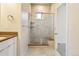 Shower with glass enclosure, marble tile, and built-in seat at 163 S Harrison St, Denver, CO 80209