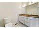 Modern bathroom with double vanity and a toilet at 163 S Harrison St, Denver, CO 80209