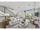 Open living space with glass garage door and modern furniture at 163 S Harrison St, Denver, CO 80209