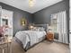 Guest bedroom with a gray upholstered bed and mid-century modern decor at 18472 W 95Th Pl, Arvada, CO 80007