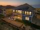 Home exterior at dusk with solar panels and bocce ball at 18472 W 95Th Pl, Arvada, CO 80007