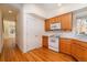Bright kitchen with wood cabinets, white appliances, and hardwood floors at 818 S Terry St # 85, Longmont, CO 80501