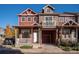 Two-story townhome with a red brick facade and a front porch at 818 S Terry St # 85, Longmont, CO 80501