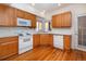 Kitchen with wood cabinets and white appliances at 818 S Terry St # 85, Longmont, CO 80501