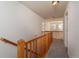 Upstairs hallway with wood railing and carpet flooring at 818 S Terry St # 85, Longmont, CO 80501