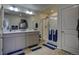 Bathroom with double vanity and large shower at 45780 Silverdrop Ave, Bennett, CO 80102