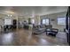 Open concept living room, kitchen, and dining area with hardwood floors at 45780 Silverdrop Ave, Bennett, CO 80102