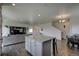 Open concept kitchen with granite island and breakfast bar at 45780 Silverdrop Ave, Bennett, CO 80102