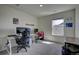 Bedroom with two workspaces and a gaming chair at 45780 Silverdrop Ave, Bennett, CO 80102