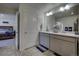 Double vanity bathroom with access to bedroom at 45780 Silverdrop Ave, Bennett, CO 80102