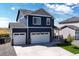 Two-story blue house with white two-car garage and landscaping at 45780 Silverdrop Ave, Bennett, CO 80102