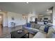 Spacious living room with sectional sofa, and view of kitchen at 45780 Silverdrop Ave, Bennett, CO 80102