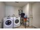 Laundry room with washer, dryer, and storage at 45780 Silverdrop Ave, Bennett, CO 80102