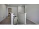 Upper hallway with laundry room and staircase access at 45780 Silverdrop Ave, Bennett, CO 80102
