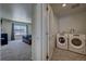 Upper level laundry room with washer and dryer at 45780 Silverdrop Ave, Bennett, CO 80102