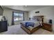 Spacious bedroom with wood bed frame and window at 45780 Silverdrop Ave, Bennett, CO 80102