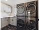 Modern laundry room with front load washer and dryer at 4233 Vallejo St, Denver, CO 80211