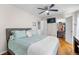 Bright bedroom with wood floors, walk-in closet, and ceiling fan at 21465 E 55Th Ave, Denver, CO 80249