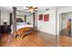 Main bedroom with large four-poster bed, hardwood floors and access to bathroom at 21465 E 55Th Ave, Denver, CO 80249