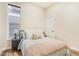 Cozy bedroom with light walls and a comfortable bed at 614 W 4Th Ave, Denver, CO 80223